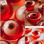 Spooky Halloween eyeball jello shots with red jello served in clear cups as festive themed food